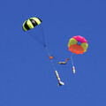 Colorful rocketry and drone parachutes fully expanded and in descent after ejection from rockets