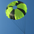 Yellow and black rocketry and drone parachute in flight and fully expanded after ejection from UAV