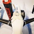 Closeup of a drone with a drone parachute recovery system securely mounted to the airframe by a harness