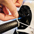 Demonstration of securing a drone parachute harness on the arms of a drone using a zip tie