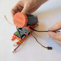 Demonstration of securing a drone parachute launcher to a mounting plate