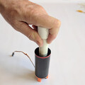 Demonstration of pushing down the piston of a drone parachute launcher