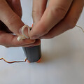 Demonstration of z-folding the shock cord of a drone parachute after packing the canopy in the canister