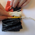 Demonstration of aligning shroud lines over the canopy of a drone parachute