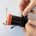 Demonstration of securing a drone parachute launcher to a mounting plate