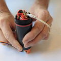Demonstration of packing a drone parachute into the launcher canister