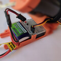 Closeup view of a drone parachute automatic trigger system connected to a drone parachute launcher
