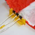Parachute with neatly separated shroud lines secured in a parachute folding and rigging jig