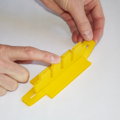Demonstration of inserting the line separator into the base of a parachute folding and rigging jig