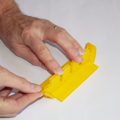 Demonstration of inserting the line separator into the base of a parachute folding and rigging jig