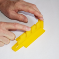 Demonstration of inserting the line separator into the base of a parachute folding and rigging jig