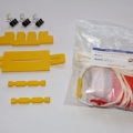 Unassembled parachute folding and rigging jig next to an unfolded parachute