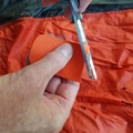 Demonstration of cutting kite tape for patching a parachute
