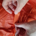 Demonstration of applying a patch to a damaged parachute canopy