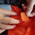 Demonstration of applying a patch to a damaged parachute canopy