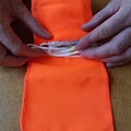 Demonstration of z-folding the parachute shock cord and placing it next to the parachute