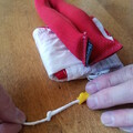 Side view of a folded drone parachute with a weight on top