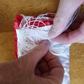 Demonstration of z-folding the shroud lines of a drone parachute
