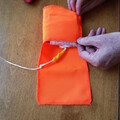 Demonstration of folding a parachute liner over a parachute