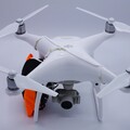 Front view of a drone with parachute harnesses securing a drone parachute recovery system to the airframe