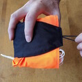 Demonstration of pull the flap over the shock cord's end loop