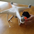 Demonstration of positioning a packed drone parachute on the drone airframe for mounting
