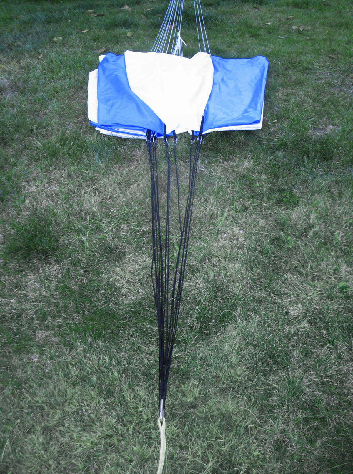 Straight-ahead view of parachute stretched out with attached load harness