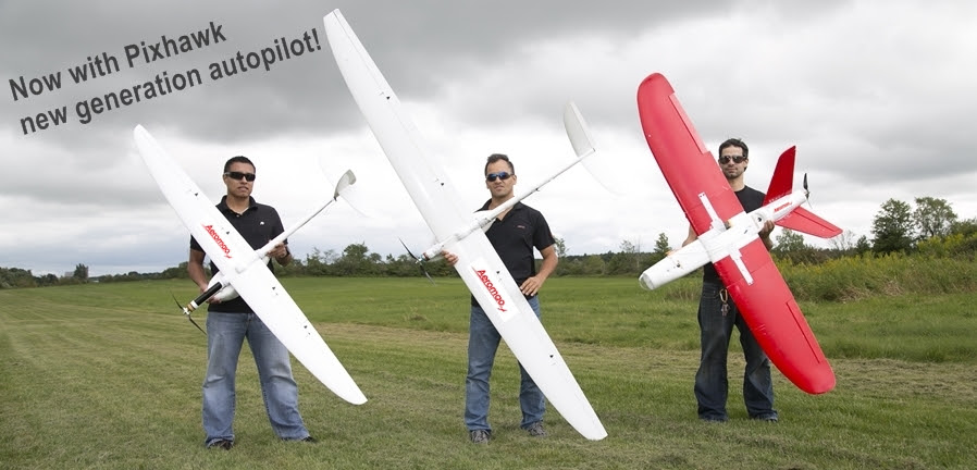 Aeromao team holding fixed wing drones with integrated parachutes