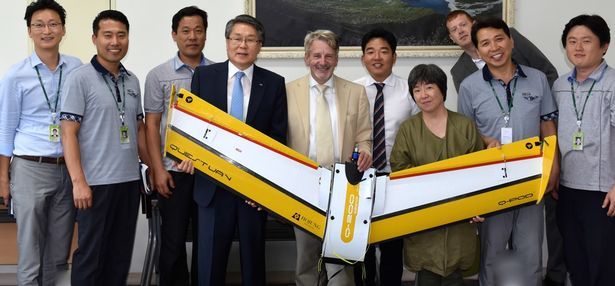 Nige and partners from South Korea holding a fixed wing aircraft